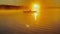 Kayaker floats on calm water through the morning fog above the water at sunrise, the silhouette of a man with a paddle
