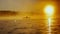 Kayaker floats on calm water through the morning fog above the water at sunrise, the silhouette of a man with a paddle