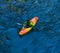 A kayaker goes down on a kayak on a mountain river Belaya in Adygea in the autumn time, the top view