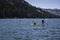 Kayaker and Paddle Boarder on lake in California, USA