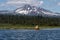 Kayaker paddling on beautiful mountain lake near Bend, Oregon