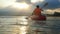 Kayaker paddling at beautiful sunset and water droplets splashing and lens flare effects. slow motion. 1920x1080