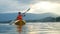 Kayaker paddling at beautiful sunset and water droplets splashing. Satisfied happy summer vacation rest relax recreation