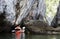 Kayaker Paddling through Caves