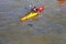 Kayaker paddling through polluted waterway. Thames River, London, England