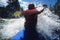 Kayaker Paddling Through Rapids