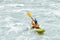 Kayaker paddling in white water rapids