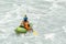 Kayaker paddling in white water rapids, with copy space