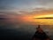 Kayaker pauses to look at glowing Alaskan sunset in remote waters