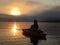 Kayaker watching sunrise Masabesic Lake, NH.