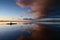 Kayakers on Coot Bay in Everglades National Park under dramatic sunset clouds.