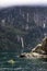 Kayakers enjoy the scenery and waterfalls of Milford Sound, one of New Zealand`s most popular tourist destinations