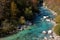 Kayakers paddling on the clear turquoise waters of the Soca River in the mountains of northern Slovenia