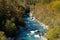 Kayakers paddling on the clear turquoise waters of the Soca River in the mountains of northern Slovenia