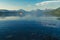 Kayakers paddling on Lake McDonald in Glacier National Park on calm water in the summer evening