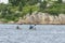 Kayakers paddling toward rocky shoreline on Palmer Island