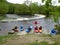 Kayakers preparing to enter river at waterfall