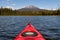 Kayaking beautiful lake in summer toward mountain peak