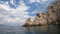 Kayaking in the blue and turquoise waters of the Peloponnese, Greece, close to a rocky promontory with a lone goat