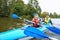 Kayaking on a calm river, young people rafting on the river