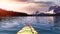 Kayaking in a glacier lake during a vibrant sunny summer morning.