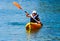 Kayaking lessons. Boy with life buoy suit in kayak lessons duri