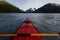 Kayaking portage lake in Alaska wilderness on summer day