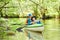 Kayaking on river in forest. Family on canoe. Active recreation and vacation