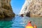 Kayaking through rock formations, Melos, Greece