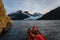 Kayaking to glacier in Alaska wilderness on sunny summer day