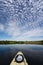 Kayaking under beautiful summer cloudscape reflected on Nine Mile Pond in Everglades National Park, Florida.