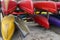 Kayaks and canoes close up stored in racks upside down in front view.