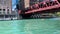 Kayaks cross under the Franklin Street elevated `el` train bridge on the Chicago River