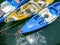 Kayaks floating on the lake and tied to the pier.