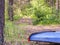 Kayaks in the forest on the grass in the parking lot of tourists.