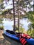 Kayaks and lifevests at edge of pond