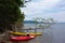 Kayaks resting on a narrow, rocky shore of Baddeck island on the Bras D`or lakes of Cape Breton