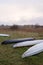 Kayaks of water tourists during a halt in the camp. Sunrise over morning swampy meadow surrounded by dry reed. Nature of Volyn