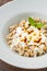 Kayseri ravioli or Kayseri Mantisi on a white plate on wooden table