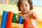 Kazakh curly girl playing in kids development center