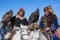 Kazakh Eagle Hunters traditional clothing, with a golden eagles during annual national competition with birds