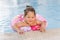 Kazakh little girl playing near swimming pool