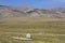 Kazakh nomadic people with their yurt and herd of sheep, in Assy Plateau, Kazakhstan