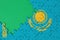 Kazakhstan flag is depicted on a completed jigsaw puzzle with free green copy space on the left side
