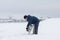 KAZAN, RUSSIA - JANUARY 19, 2017: russian MoE lifeguard cuts ice with a chainsaw - rescuer on at winter day durin