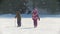 KAZAN, RUSSIA - March, 2018: two children on a winter walk, a boy skiing, a girl walking, an adult skier riding past