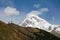 Kazbek peak mountains and blue sky.