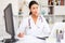 Kazhahstani female doctor in uniform is working behind laptop