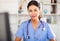 Kazhahstani female medic in uniform standing in doctor`s office