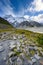 Kea Point Track in Mount Cook National Park, high rocky mountains and green grass